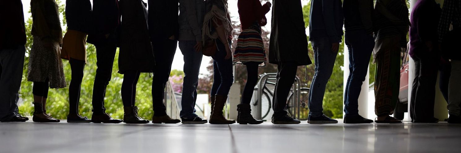 A group of people are standing in a line.