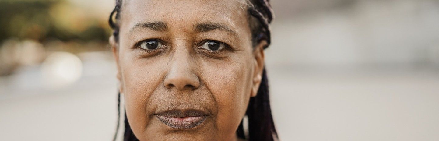 A close up of a woman 's face with a serious look on her face.