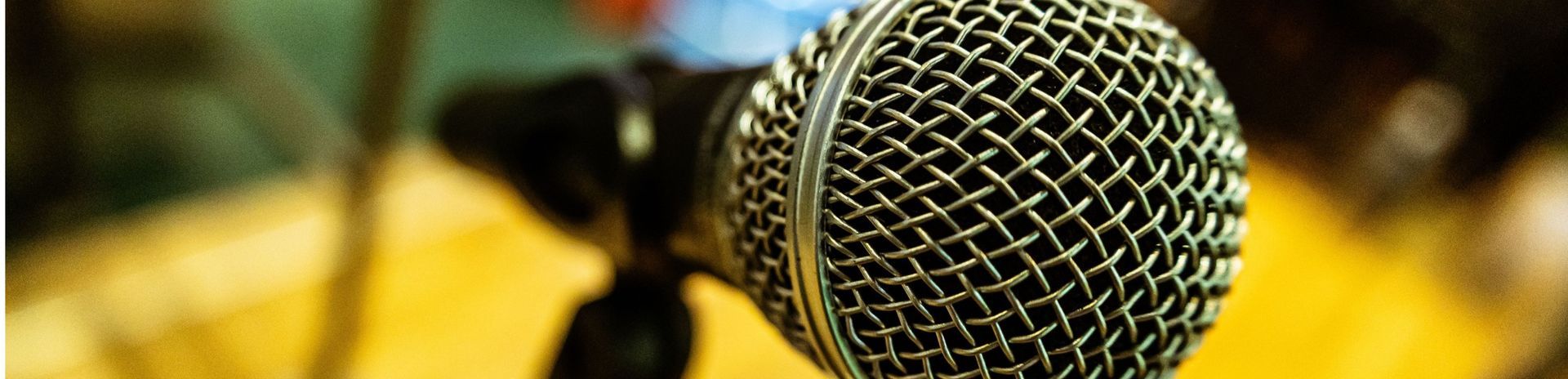 A close up of a microphone on a stand on a table.