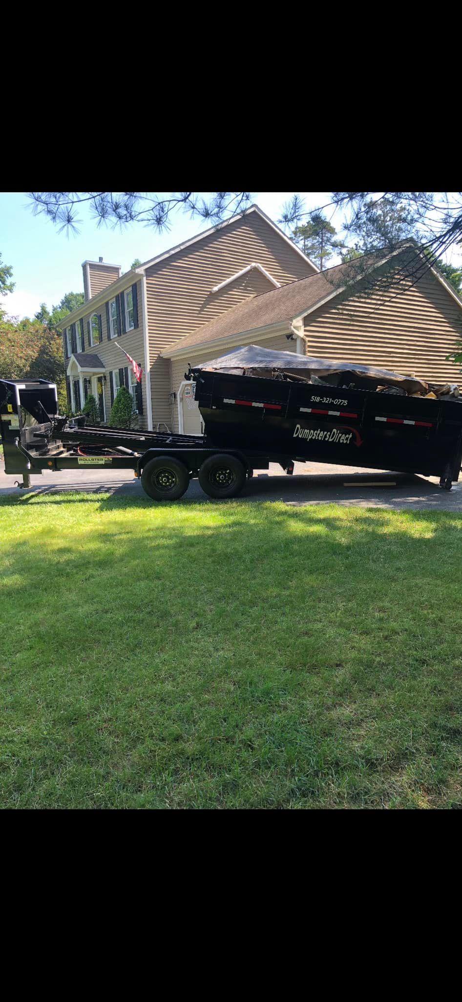 A dump truck is parked in front of a house.