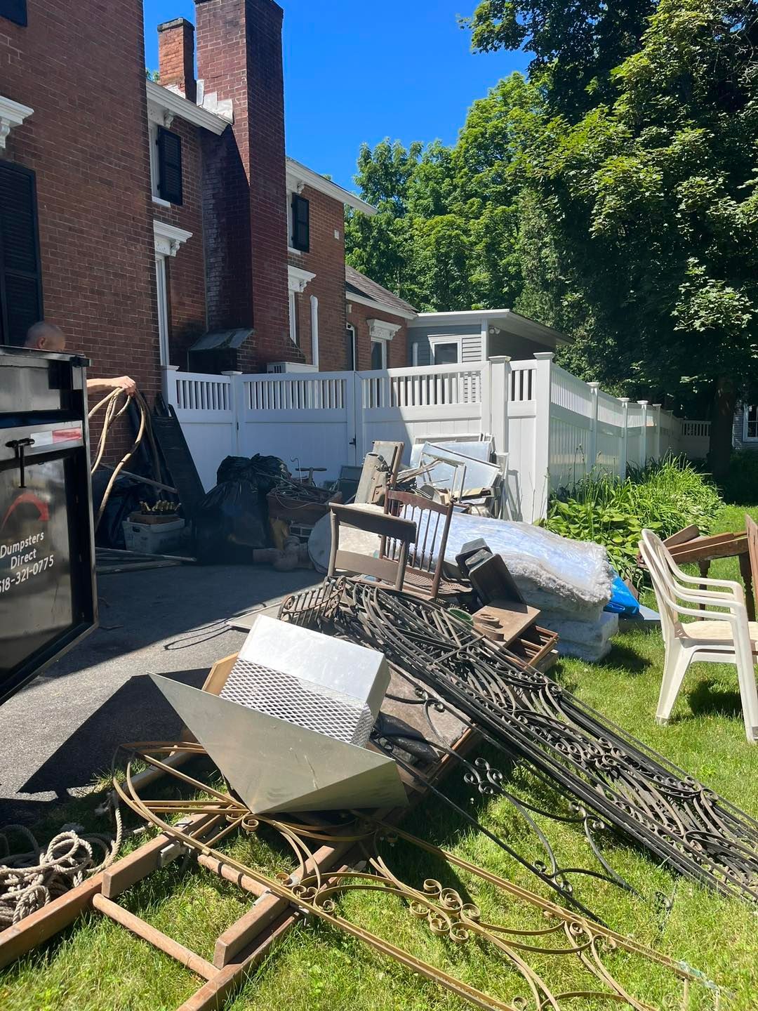 There is a lot of trash in the backyard of a house.