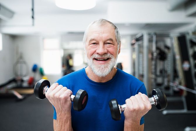 A Happy Senior Lifting Light Dumbbells