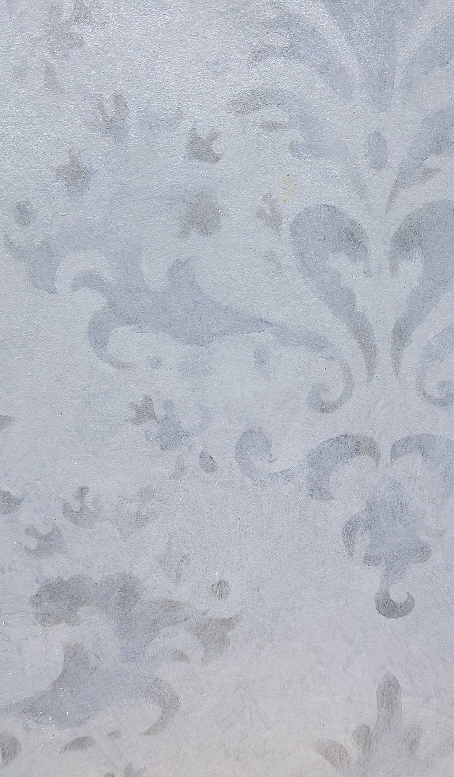 Frosted window with pale blue, floral-like patterns.