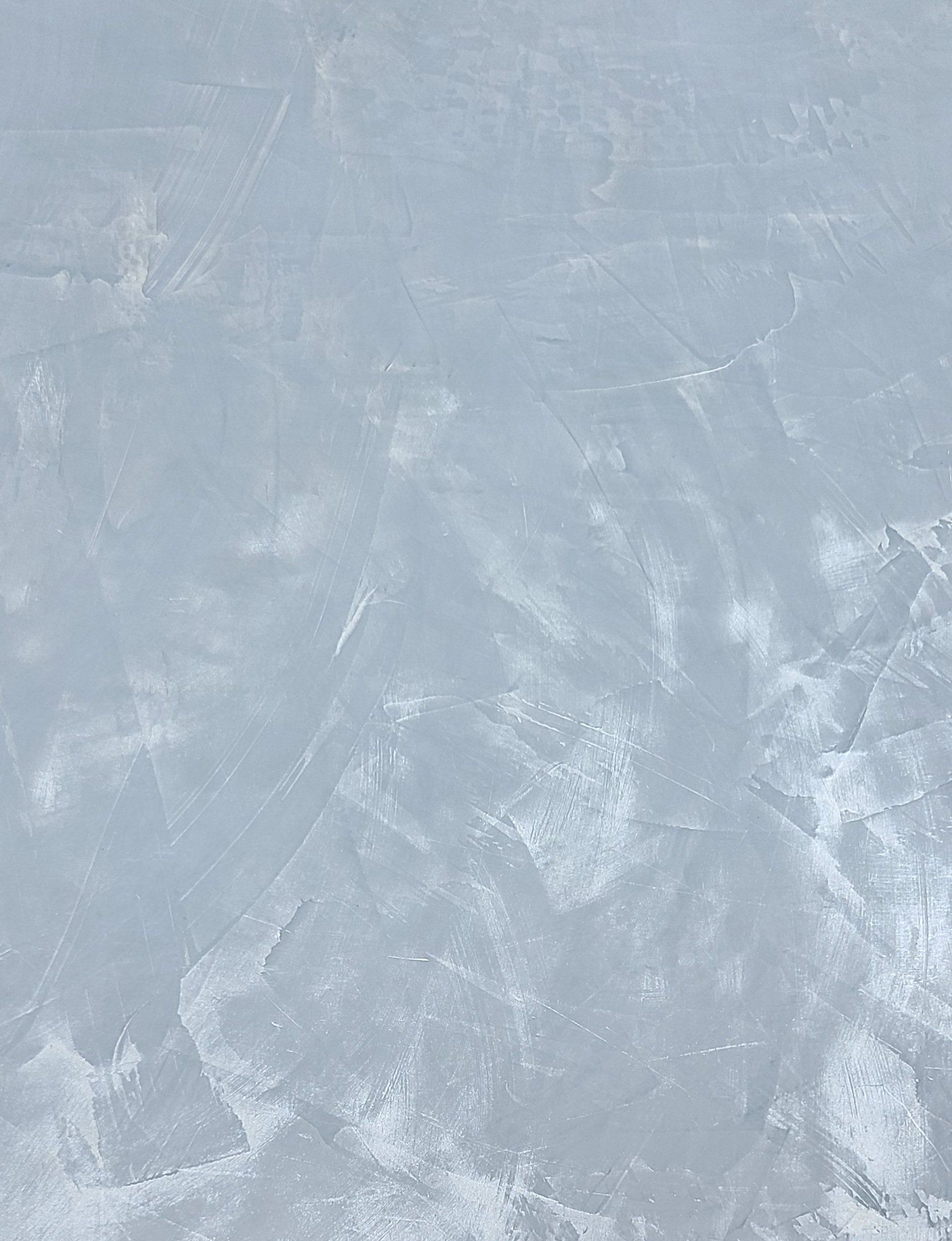 Textured light blue wall with visible brush strokes.