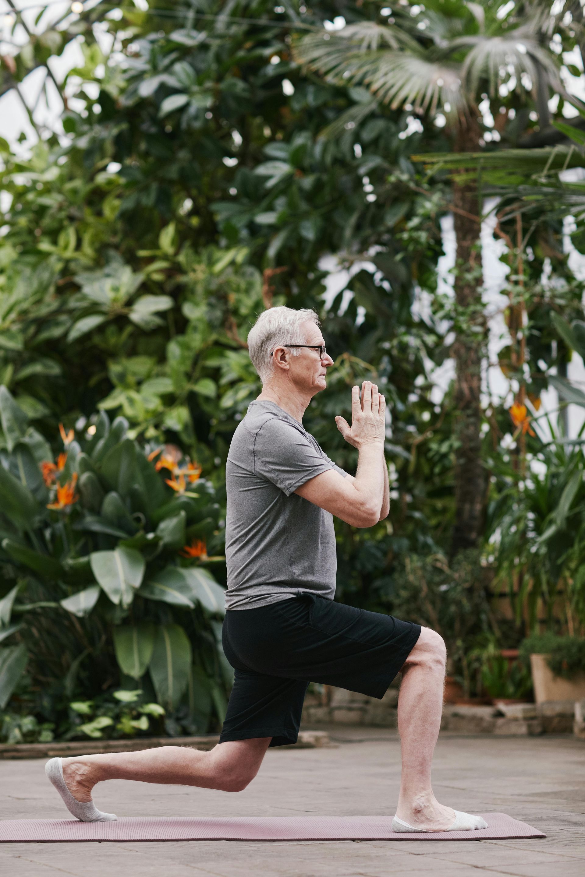 A man is doing a yoga pose on a yoga mat.