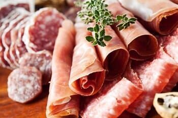 There are many different types of meat on the table.