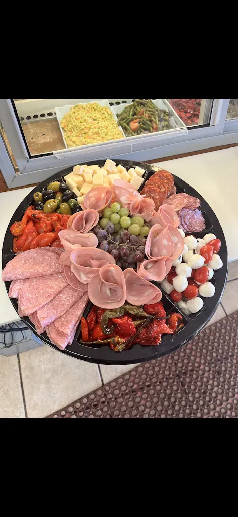 A tray of meats and vegetables on a table.