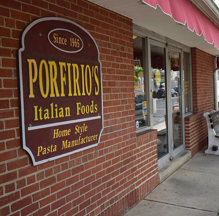 A brick building with a sign that says porfirio 's italian foods