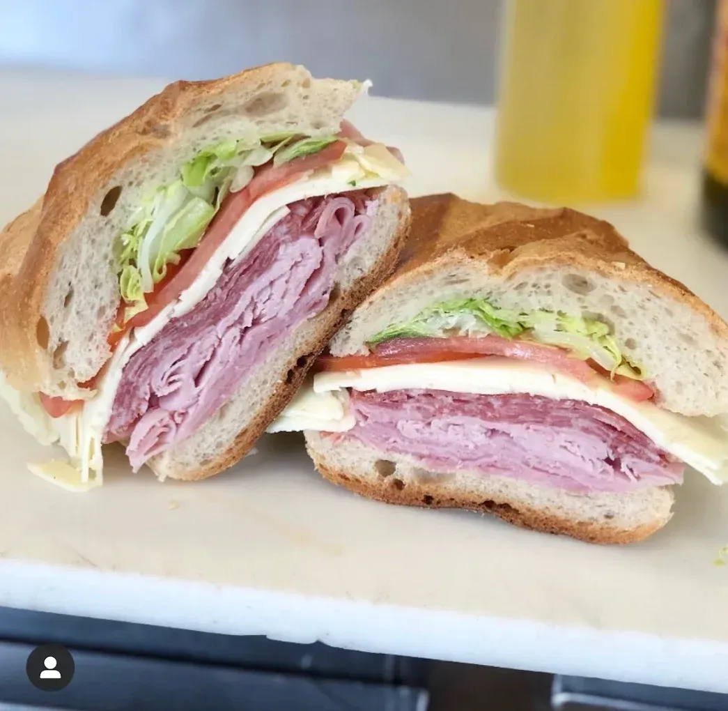 Two halves of a sub sandwich on a cutting board
