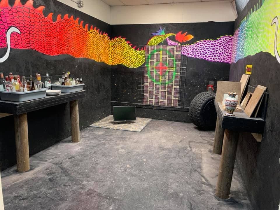 A room with a painting of a dragon on the wall