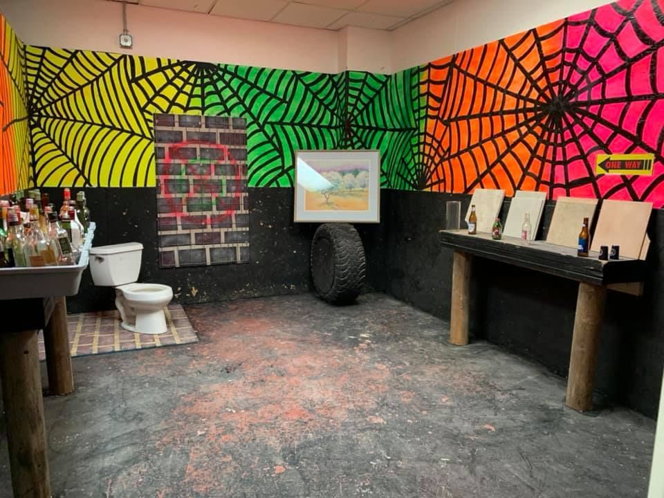 A bathroom with spider webs painted on the walls