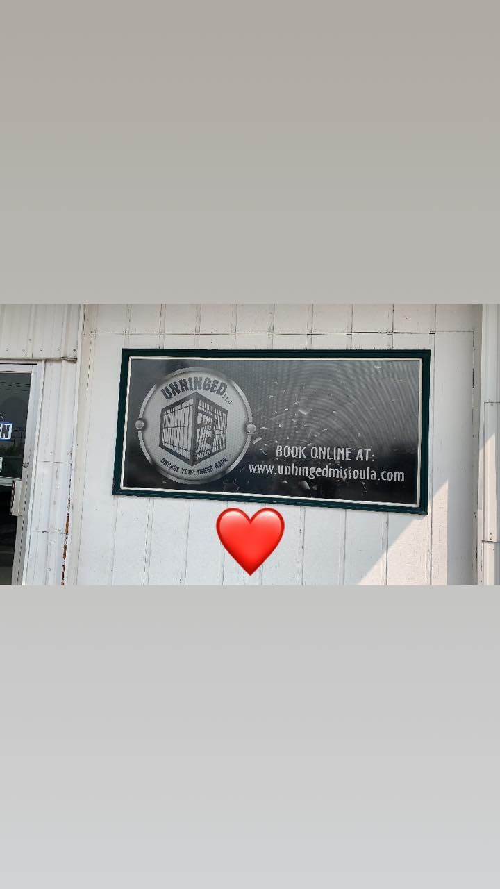 A black and white photo of a sign with a heart next to it.