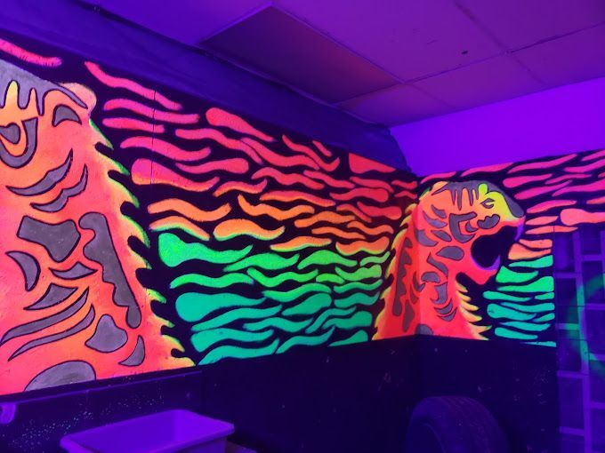 A room with glow in the dark paintings on the wall