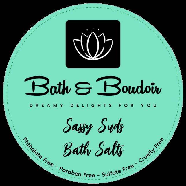 A circular, light teal label for Bath & Boudoir Sassy Suds Bath Salts featuring a lotus icon, text, and ingredient notes.