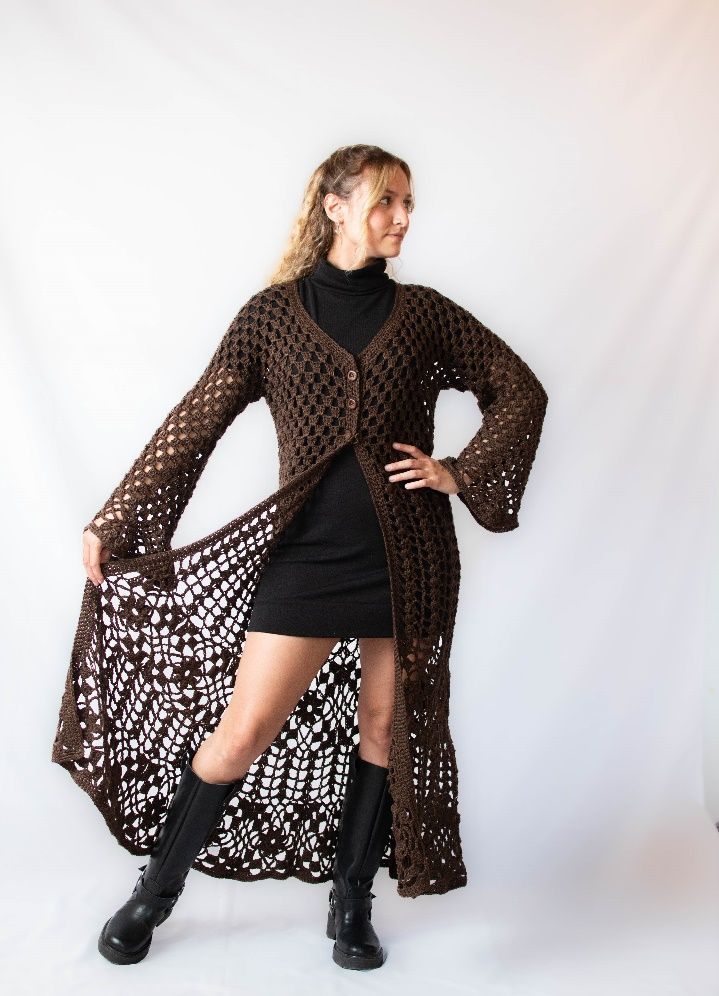 Una mujer lleva un cárdigan largo de crochet marrón.