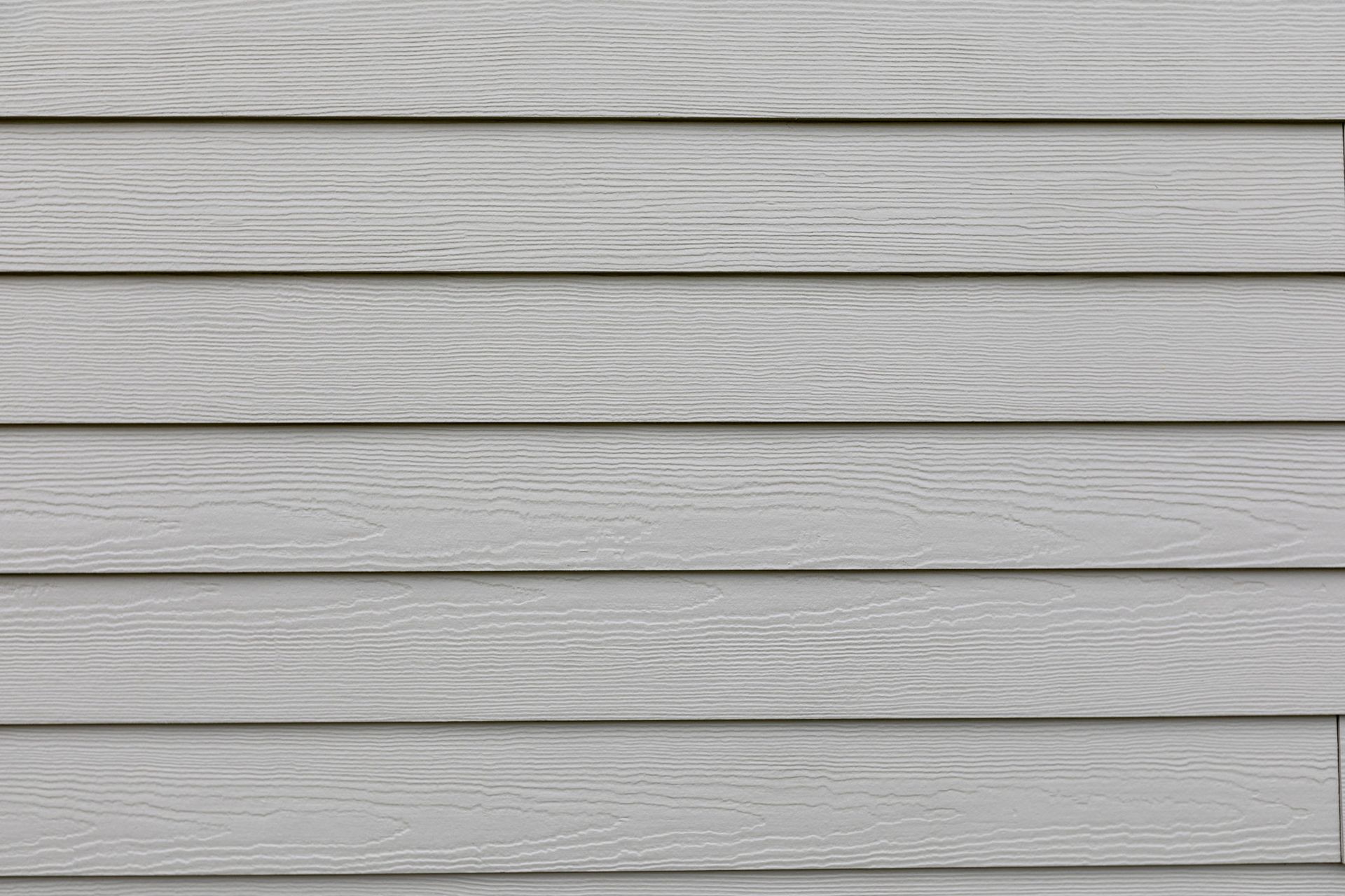 A close up of a white siding on a house.