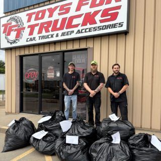 Three men stand outside