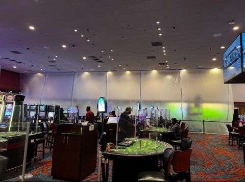 A large room with tables and chairs in a casino.