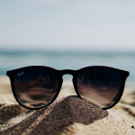 Image of Raybans on Beach Sand During the Day