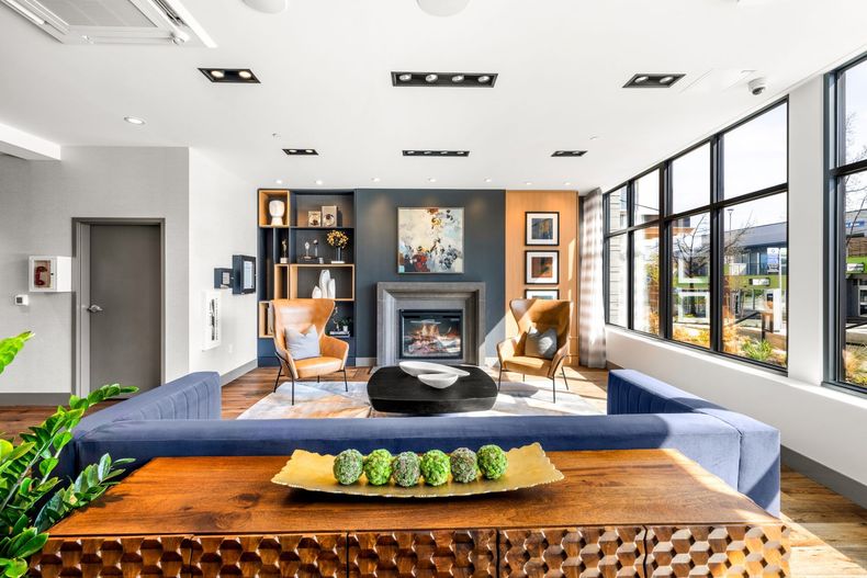 A lobby room filled with furniture and a fireplace.
