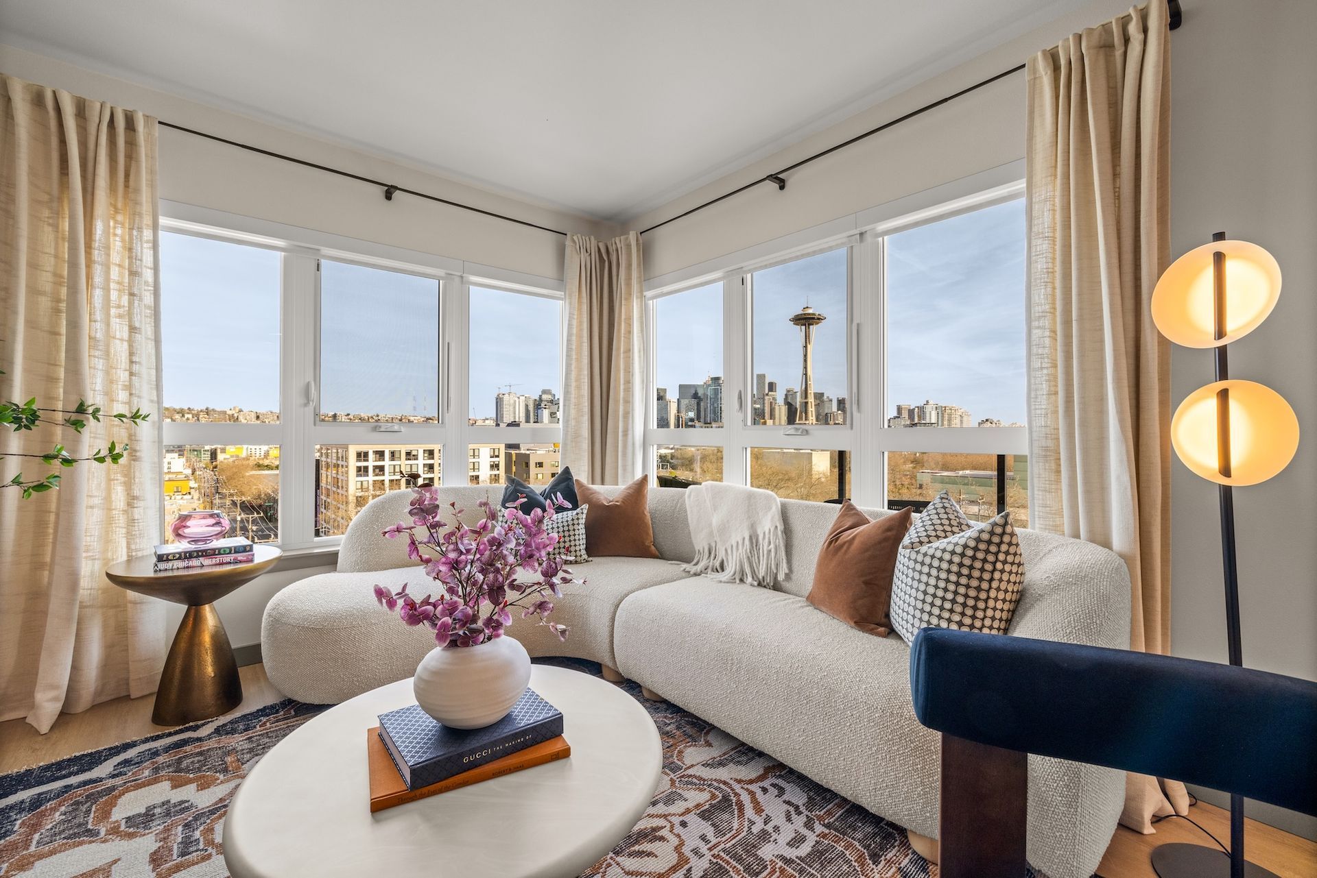 A rooftop patio with a view of the city skyline at night.