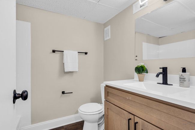 Bathroom with vanity and shower at Town Bank Manor