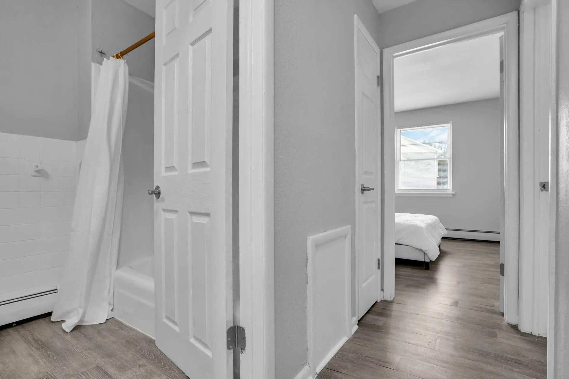 Hallway view leading to bathroom and bedroom in Town Bank Manor apartment