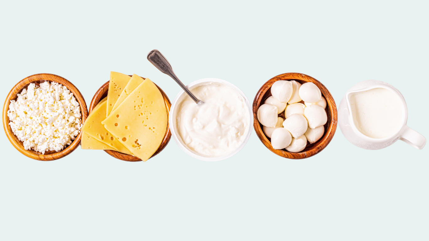 A spread of whole-foods based proteins including beans, and nuts are laid out with a dark background.
