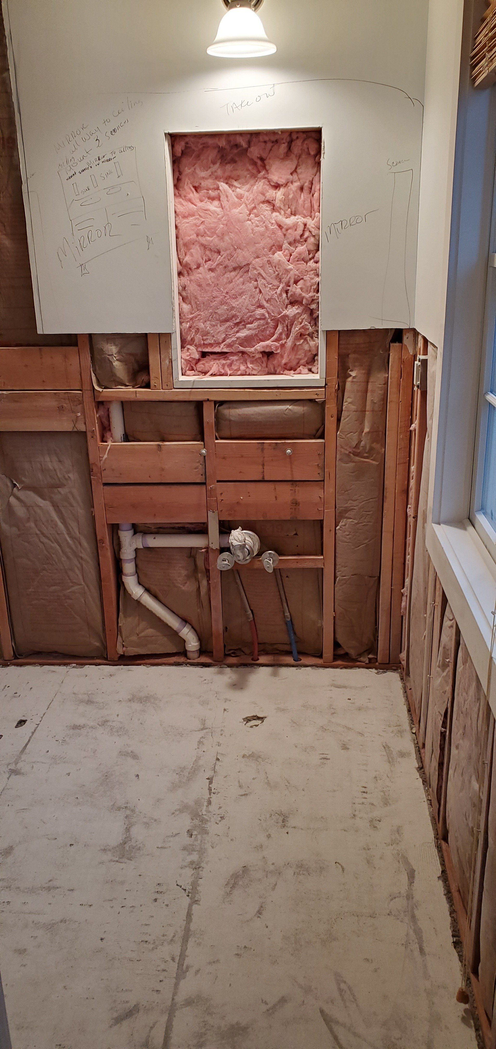 a bathroom being remodeled and the walls are being removed .