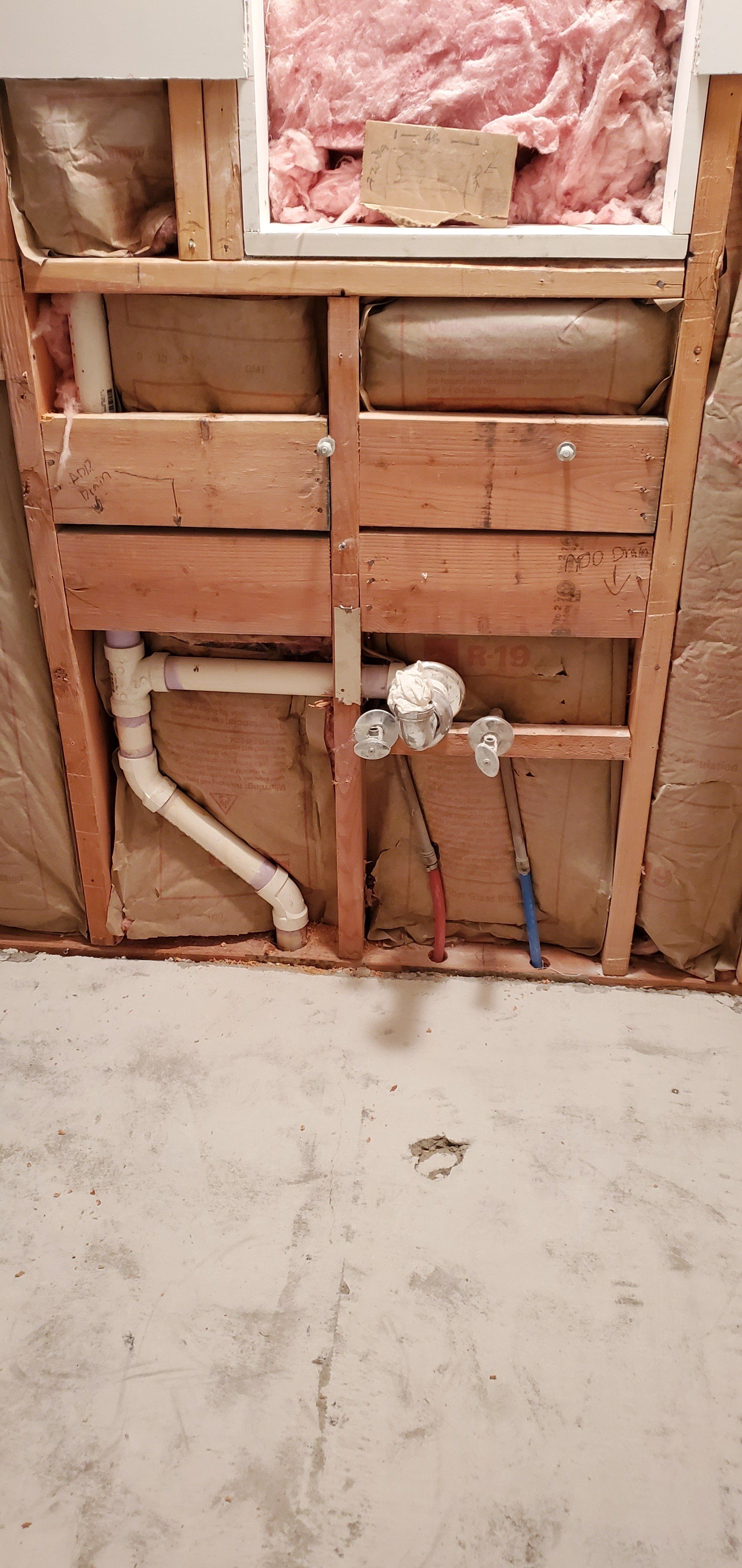 a bathroom sink is being built into a wall .