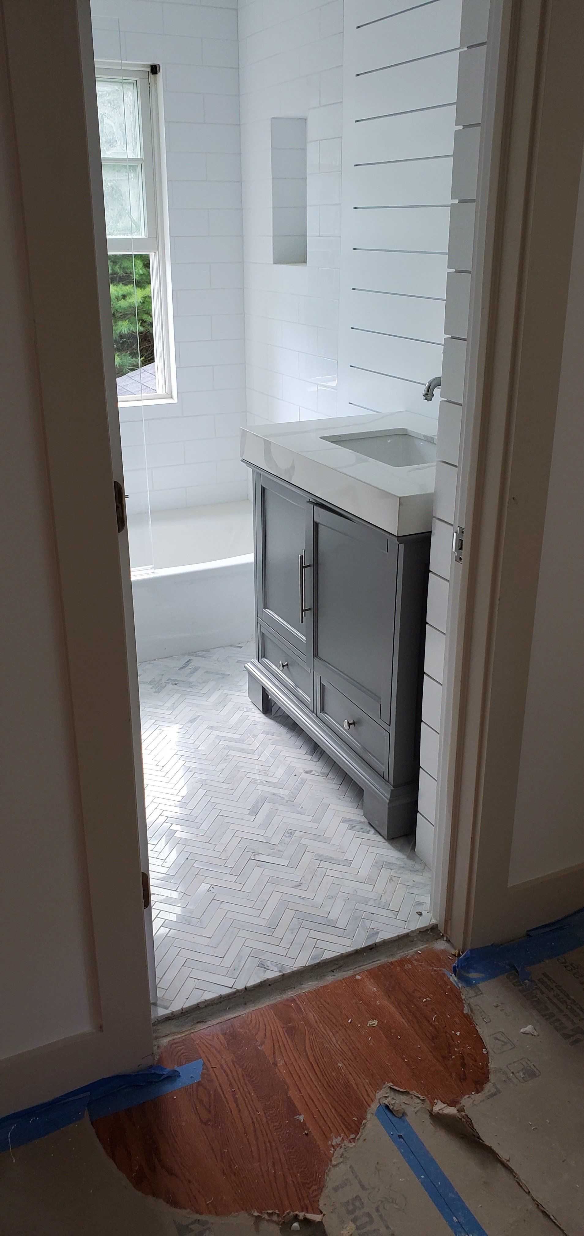 a bathroom with a sink and a bathtub in it .