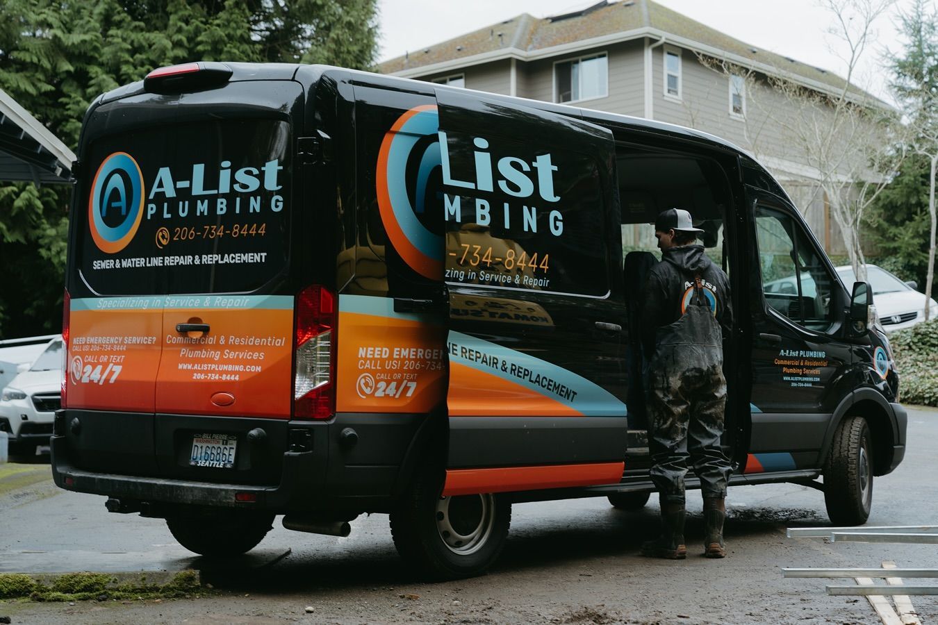 A man is standing next to a van that says Retrofit plumbing.
