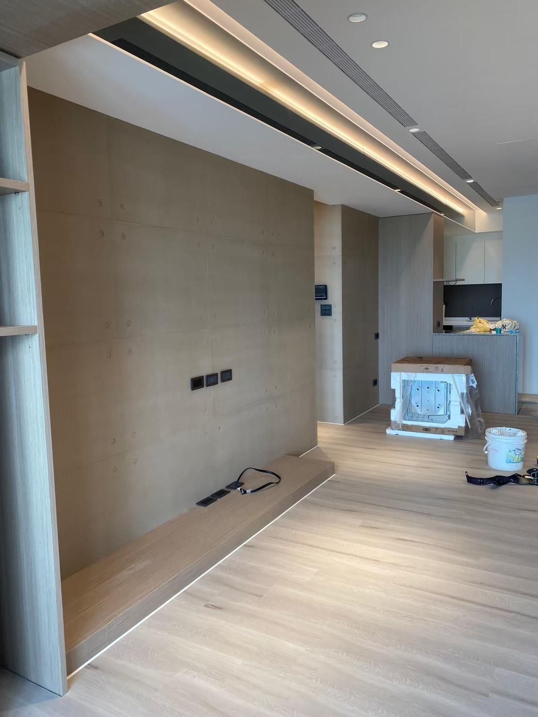 A living room with a wooden floor and a wooden wall.