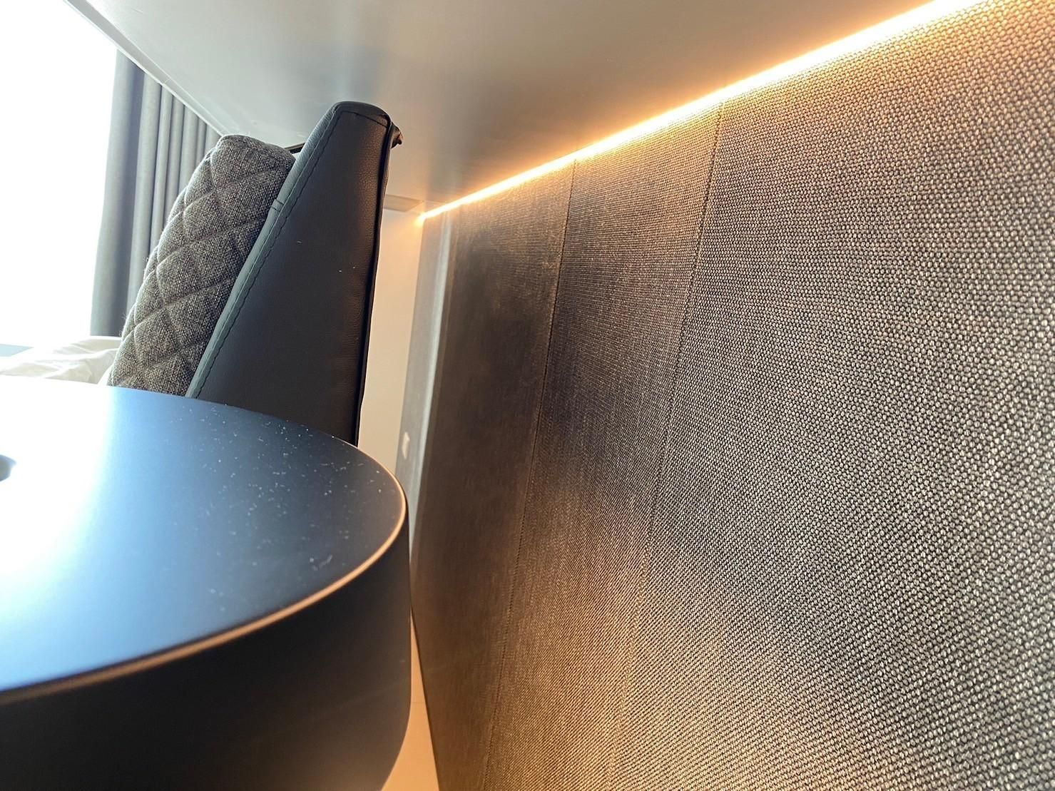 A room with a table and chairs and a wall with a pattern on it.