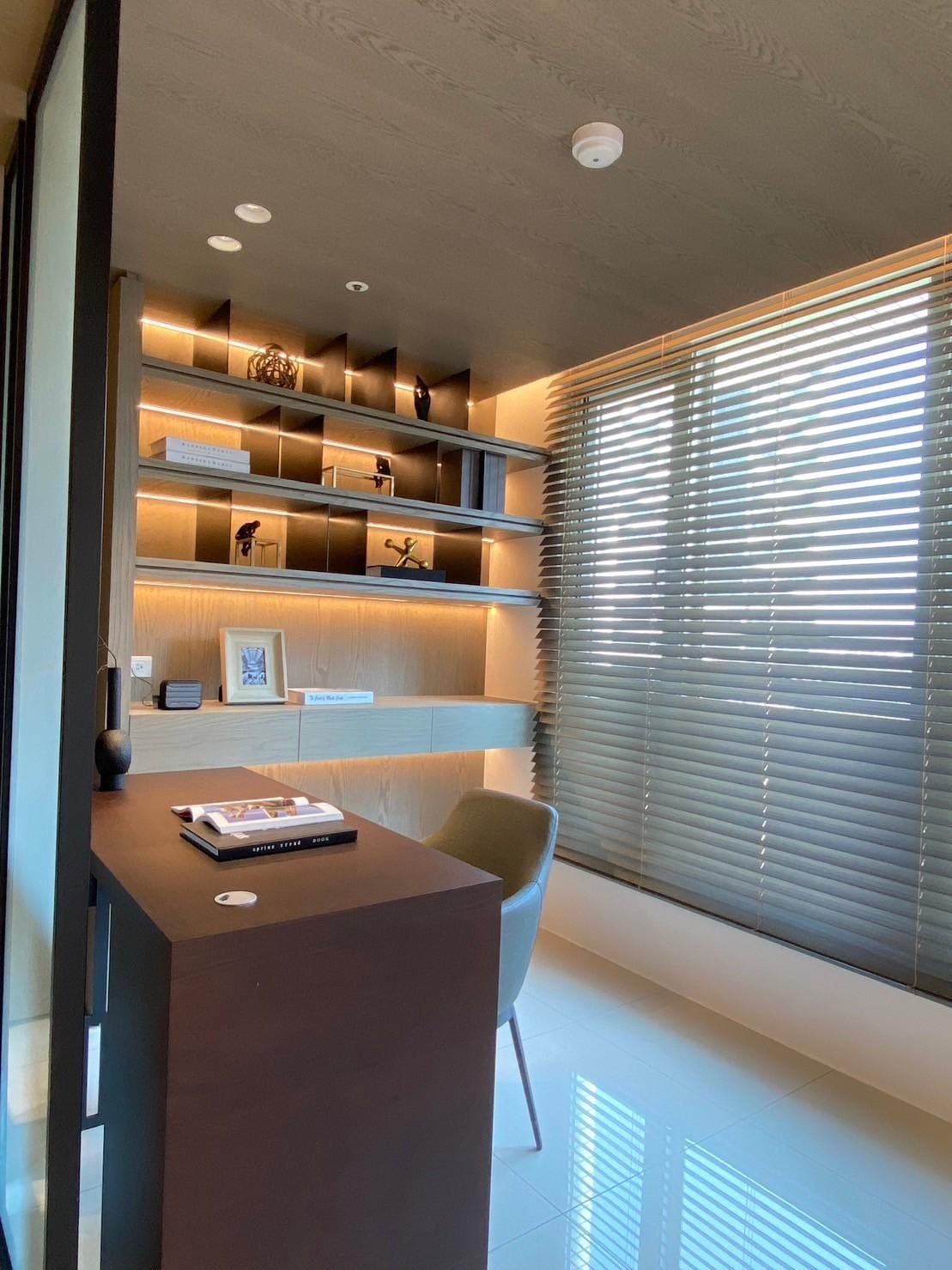 A room with a desk and a chair in it