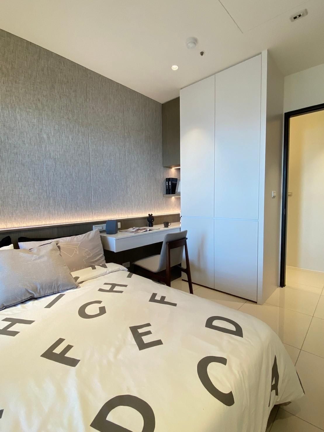 A bedroom with a bed and a desk with letters on it