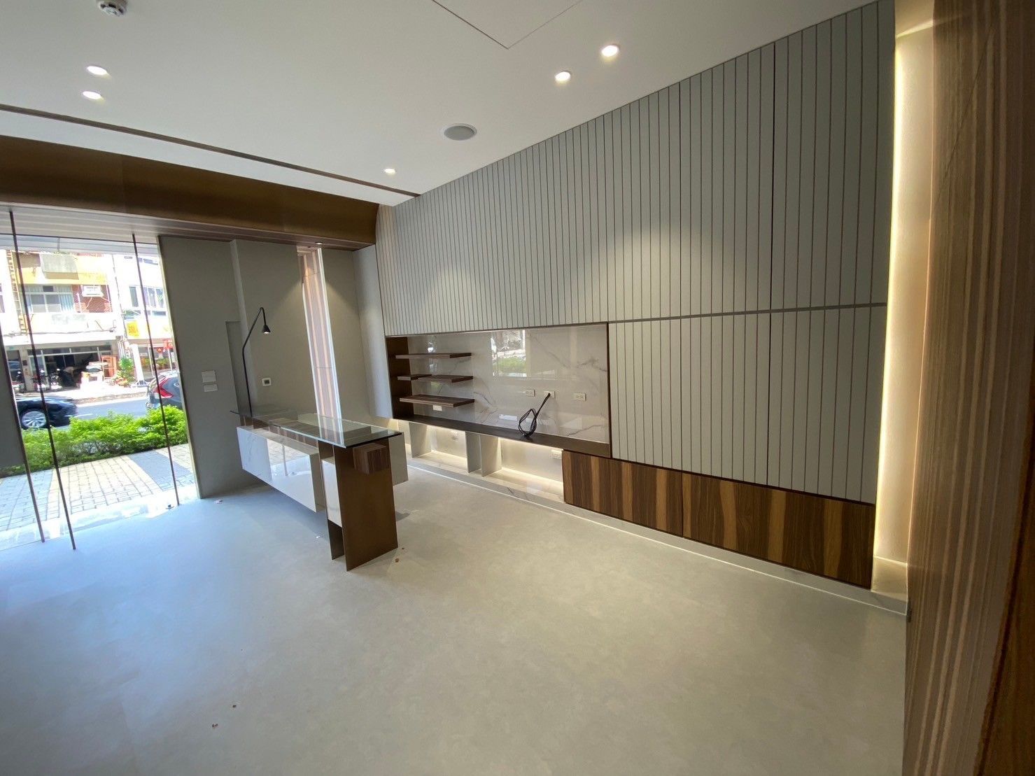 A large empty room with a counter in the middle of it.