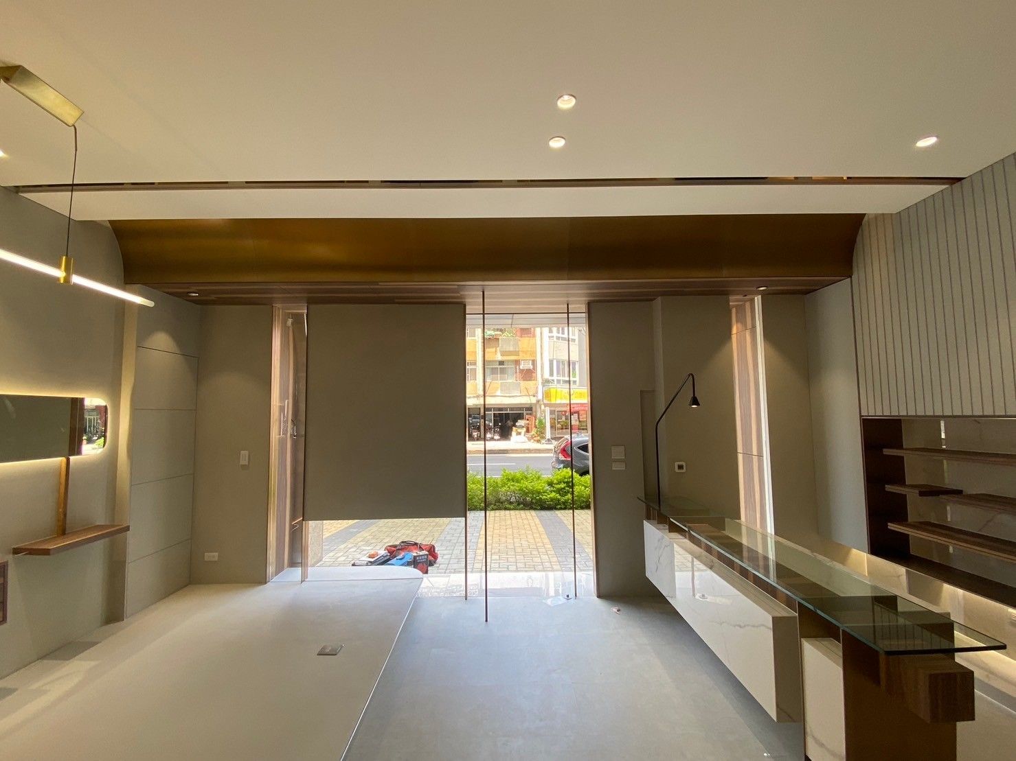 A large empty room with a glass door and a counter.