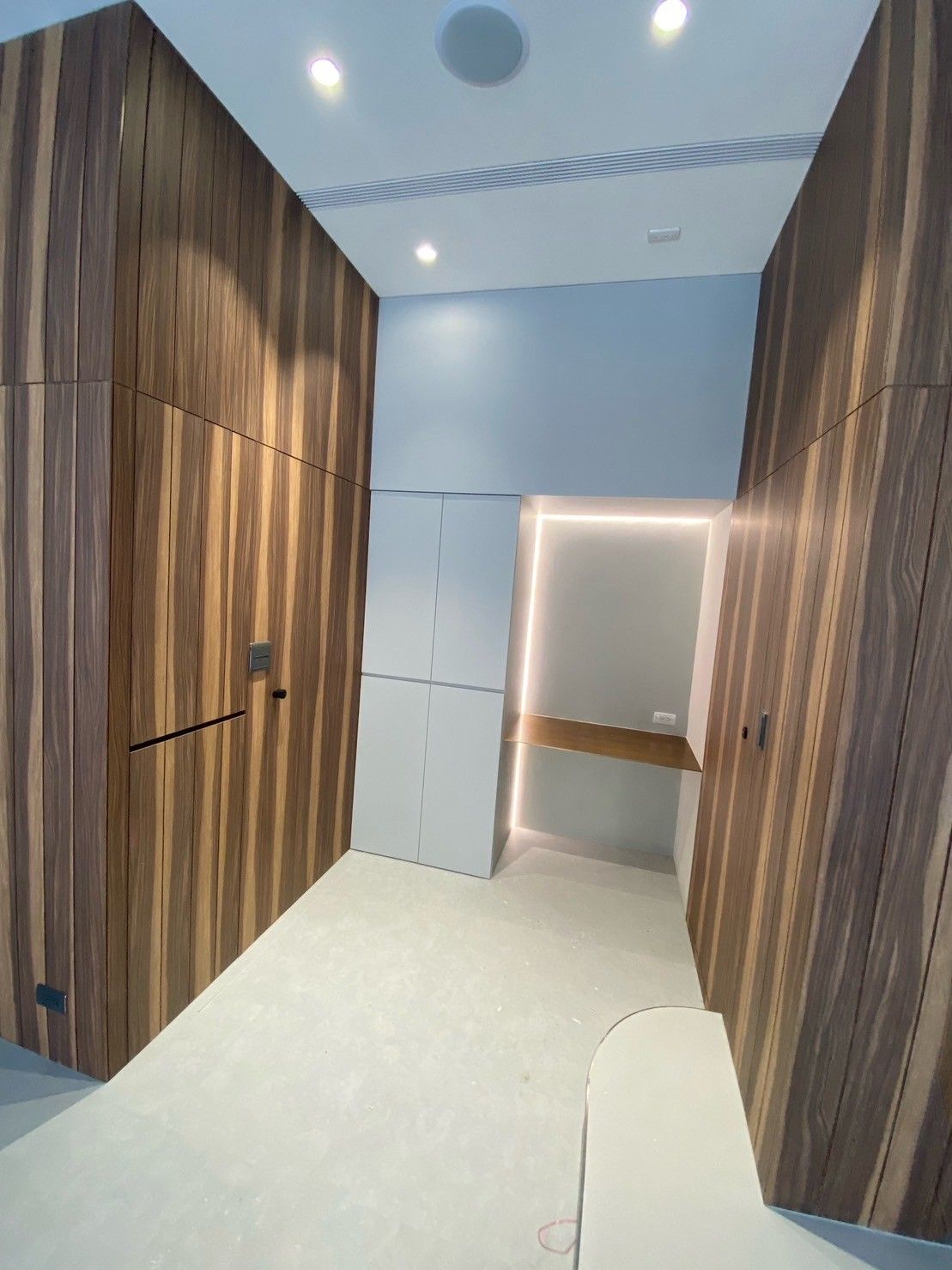 A hallway with wooden walls and a door