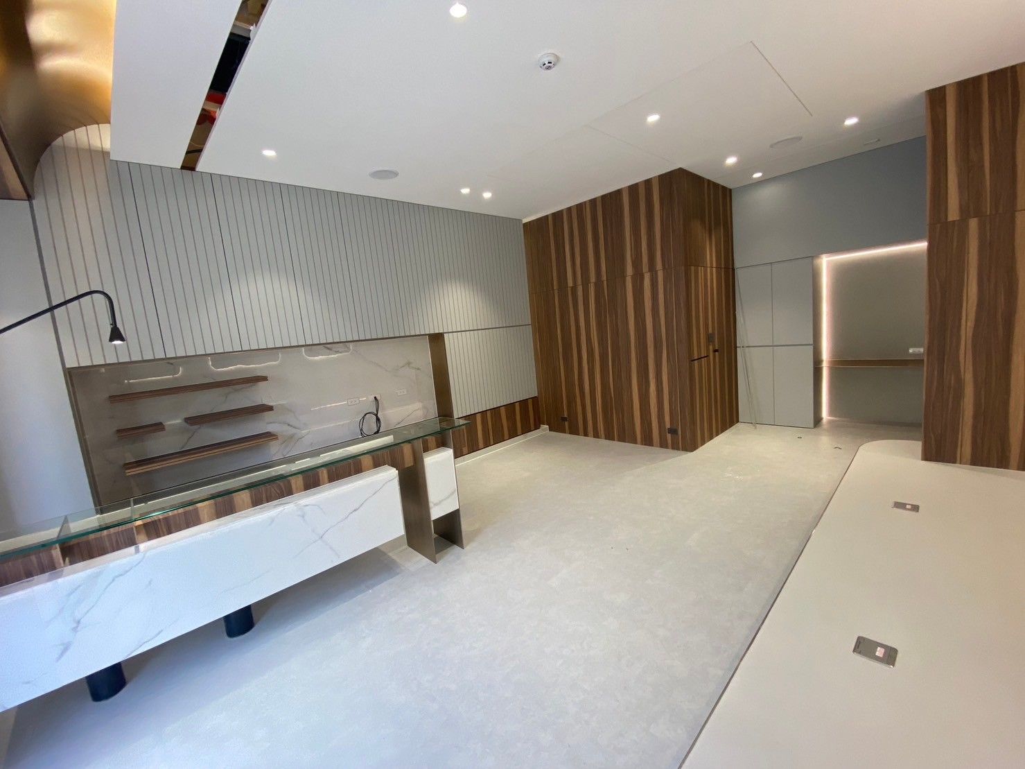 A large empty room with wooden walls and a counter.