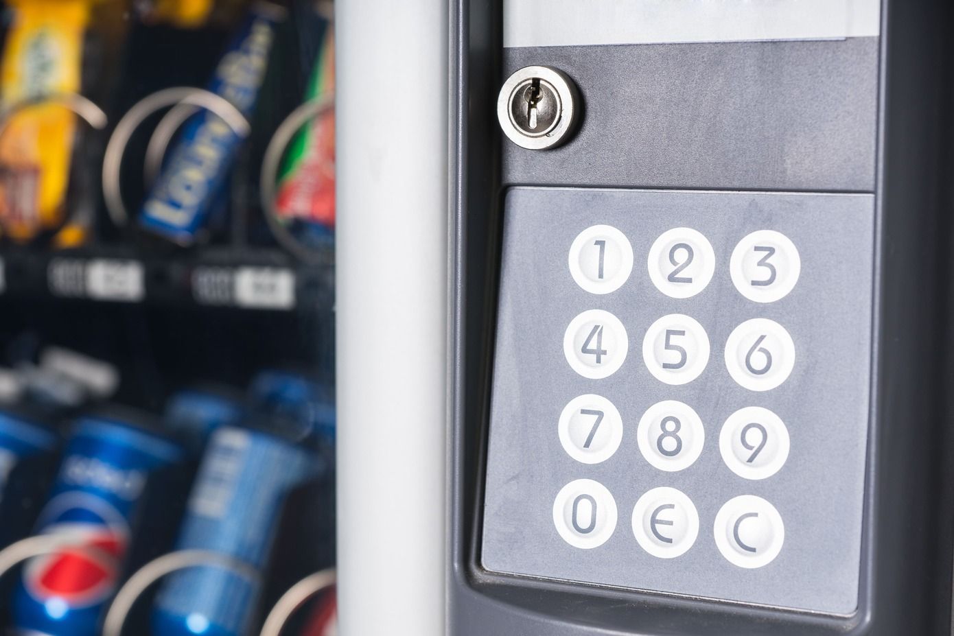 a close up of a vending machine with a keypad