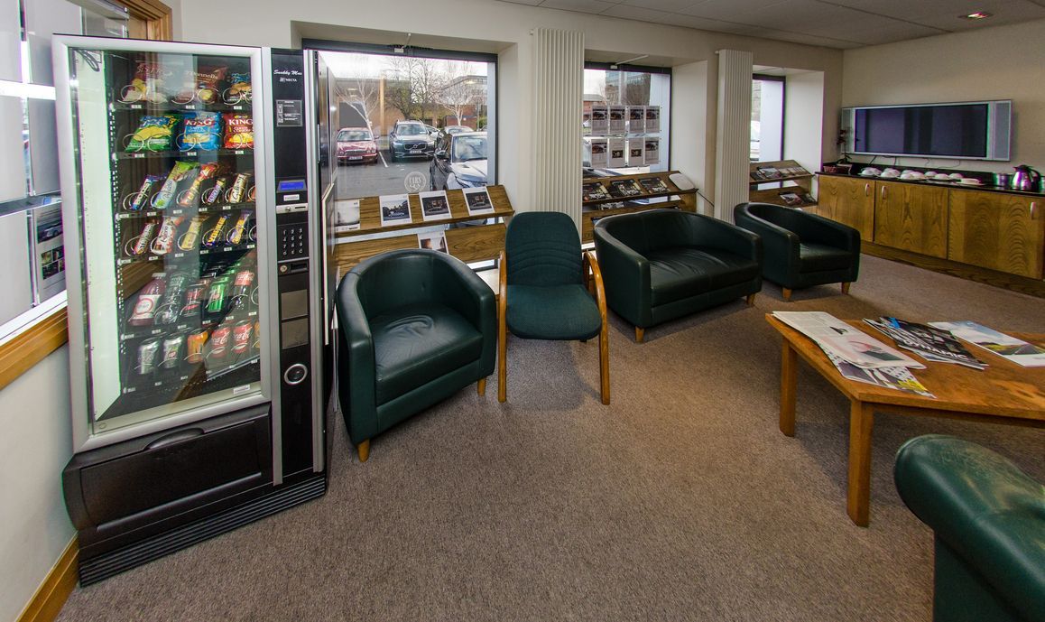 a waiting room with a vending machine and chairs