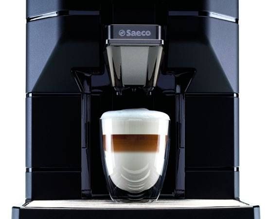 a coffee machine with a glass of coffee in it .
