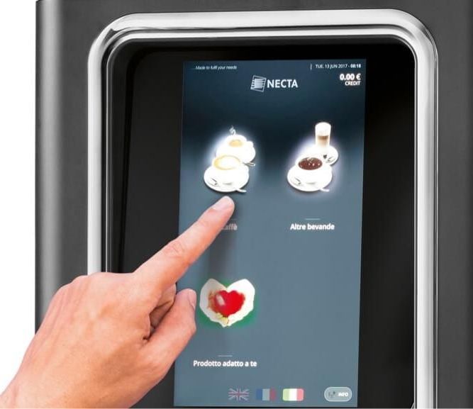 a person is touching a screen that says necta on it