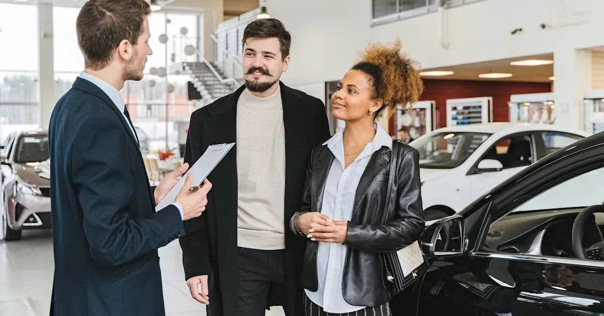 Car salesman discussing automotive marketing strategies with couple at dealership showroom.