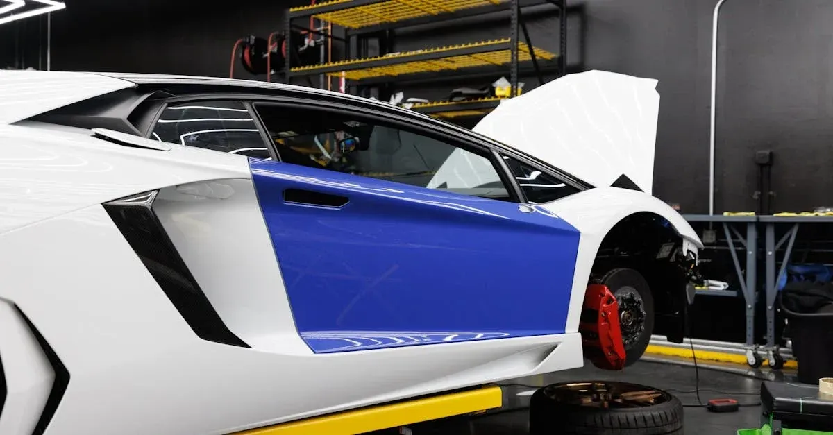 A white and blue sports car is elevated in a garage, with its front hood open and a red brake caliper visible. 