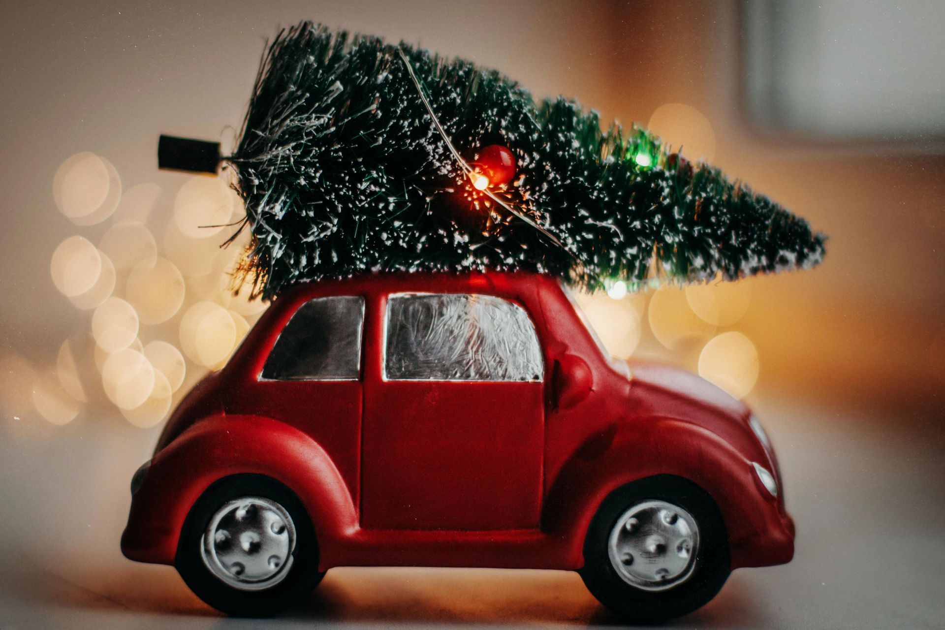 Red toy car with Christmas tree on top.