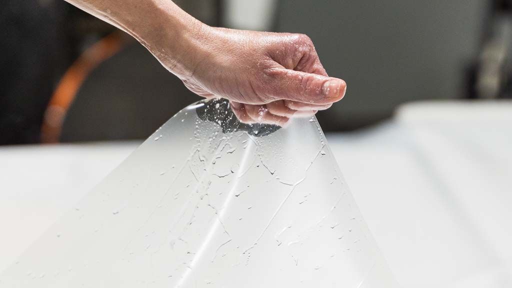 a person is holding a piece of plastic in their hand .