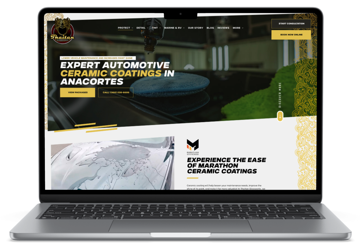 A laptop screen shows a website for window tinting paint protection film , ceramic coatings and vinyl wraps.