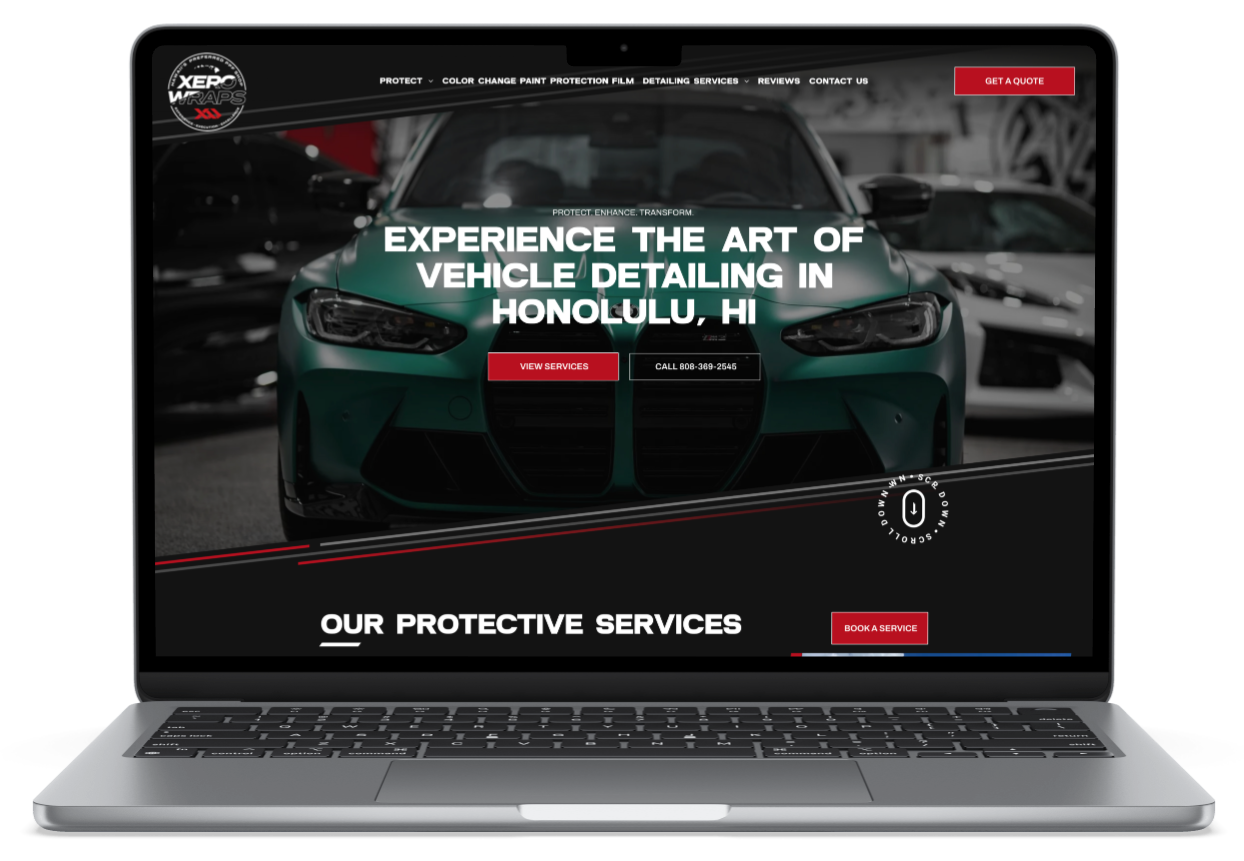 A laptop screen shows a website for window tinting paint protection film , ceramic coatings and vinyl wraps.